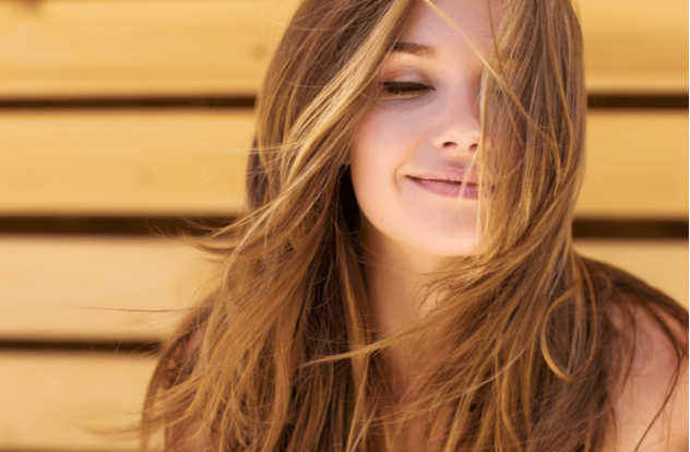 Beautiful woman smiling with hair covering her face